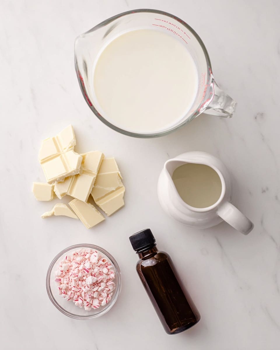 The image shows five ingredients placed on a white marbled surface. At the top center, there is a large clear glass measuring cup filled with white cream. Below and slightly to the left are irregular pieces of off-white chocolate arranged in a small pile. To the right of the chocolate, there is a white ceramic small pitcher with a handle, also filled with white cream. Below the pitcher, a small clear glass bowl holds crushed pink and white peppermint candy pieces. To the left of the peppermint bowl, a dark brown bottle with a black cap is lying flat. The setup is neat and evenly spaced photo taken with an iphone --ar 4:5 --v 7