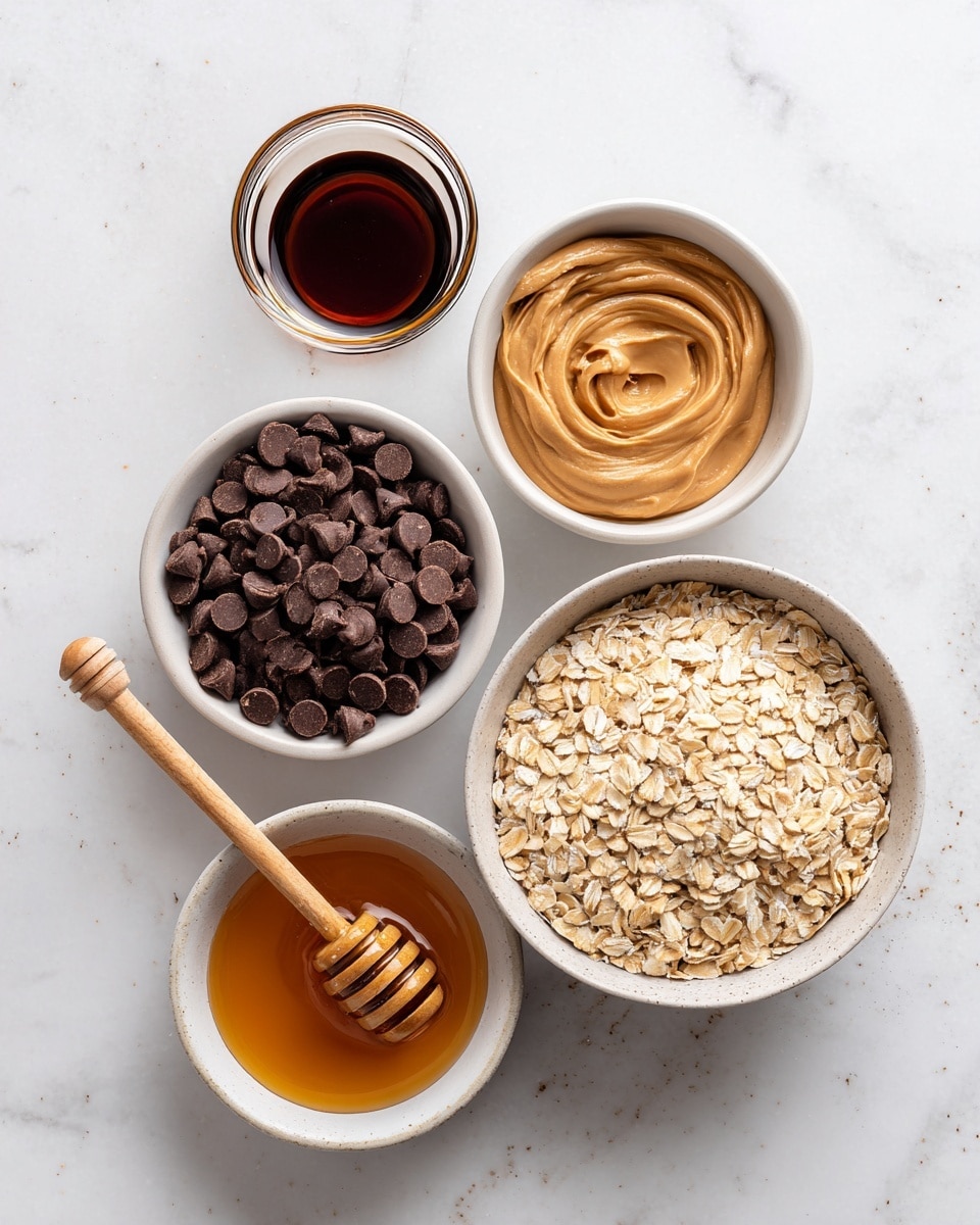 The image shows four white bowls arranged on a white marbled surface. The largest bowl at the bottom right is filled with light brown rolled oats with a coarse texture. To the top right, a medium bowl holds a smooth, creamy swirl of tan peanut butter. The top left bowl contains many dark brown chocolate chips, each small and round. At the bottom left, a small bowl holds amber-colored honey with a wooden honey dipper resting inside. There is also a small container of dark brown vanilla extract placed above the peanut butter bowl. Photo taken with an iphone --ar 4:5 --v 7