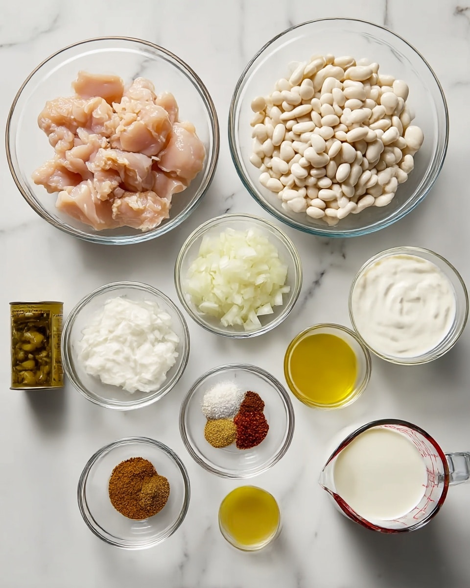 The image shows a white marbled surface with clear glass bowls and a measuring cup arranged in a neat grid. There are nine containers in total: one large bowl with small pieces of raw chicken, another large bowl filled with white beans, and a third large bowl of thick white yogurt. A medium bowl holds chopped white onions, while a small bowl contains three spices in brown, green, and red colors. Another small bowl has minced garlic. A tiny bowl holds a small amount of olive oil with a bright yellow hue. There is a small opened can of rinsed green olives, and two small opened cans of green chili peppers with visible seeds. Finally, a small clear glass measuring cup contains a white liquid that looks like milk. The setup is clean and bright, with clear contrasts between the colors of ingredients and the white marbled background. Photo taken with an iphone --ar 4:5 --v 7