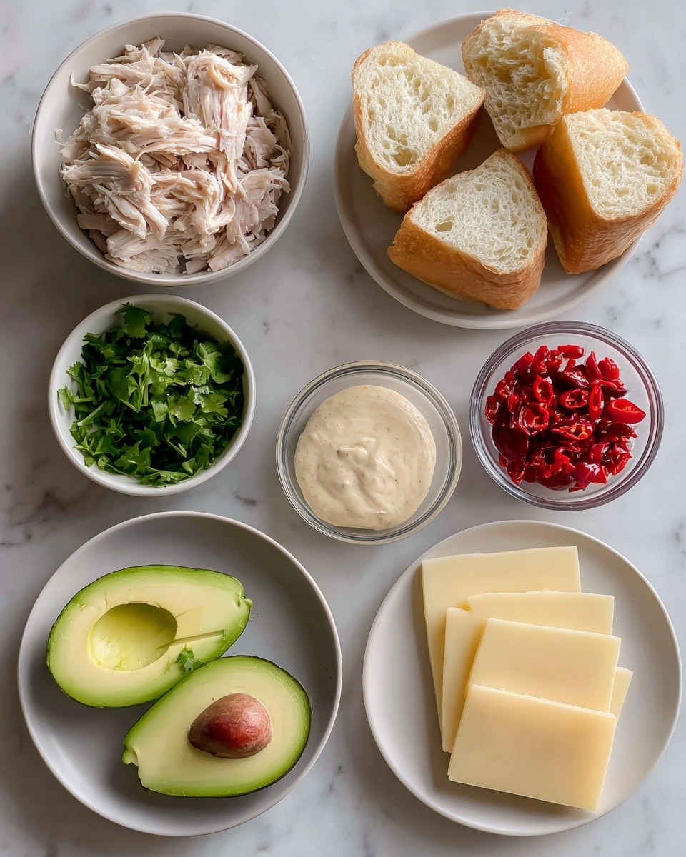 The image shows ingredients for a sandwich arranged on a white marbled surface. There are two small white bowls: one with torn light pink rotisserie chicken and the other filled with three pieces of golden-brown ciabatta bread. A small clear container holds smooth light beige chipotle mayo sauce. Next to it is a small white bowl with fresh chopped green cilantro. There is half an avocado sliced into two pieces with a bright green inside and a brown seed in one half. Bright red chopped peppadew peppers are in a small clear bowl. A plate holds five round, pale yellow slices of smoked gouda cheese with a smooth texture. The items are spaced neatly with labels above or near each bowl or plate. Photo taken with an iphone --ar 4:5 --v 7