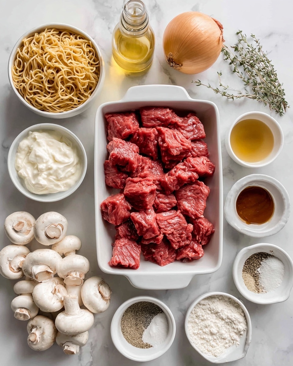 The image shows a white rectangular dish filled with chunks of raw red beef placed in the center. Around it, there are several ingredient bowls and containers arranged on a white marbled surface: a white bowl full of cooked, light brown noodles near the top left; a small glass bottle with yellow cooking oil near the top center; a white bowl with thick white sour cream to the left; a cluster of fresh white mushrooms at the bottom left; a small white bowl with reddish-brown Worcestershire sauce below the beef; a small white bowl with pale yellow mustard near the bottom center; a white bowl with light brown salt and pepper mix next to the mustard; a white bowl with a mound of white flour near the bottom right; a small white bowl with white cornstarch near the bottom left; a whole orange onion near the bottom right corner; and an open white container with a dried green herb, thyme, near the top right corner. The image is taken from above and well-lit to show all ingredients clearly photo taken with an iphone --ar 4:5 --v 7