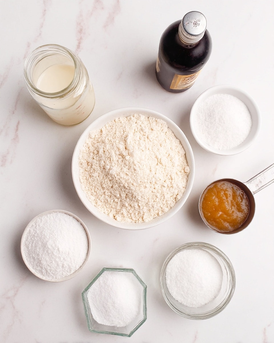 The image shows seven baking ingredients arranged on a white marbled surface. In the center is a white bowl filled with a light beige flour mixture that has a soft, grainy texture. Around it are six containers: a glass jar with an off-white liquid at the top left, a small white bowl with white powder above the flour bowl, a dark bottle with a silver cap to the right, a metal measuring cup filled with light brown applesauce at the bottom right, another glass bowl with white powder at the bottom left, a metal measuring cup filled with white sugar to the left, and a small clear hexagonal glass container with a clear liquid to the bottom right of the flour bowl. All ingredients appear ready for baking. photo taken with an iphone --ar 4:5 --v 7