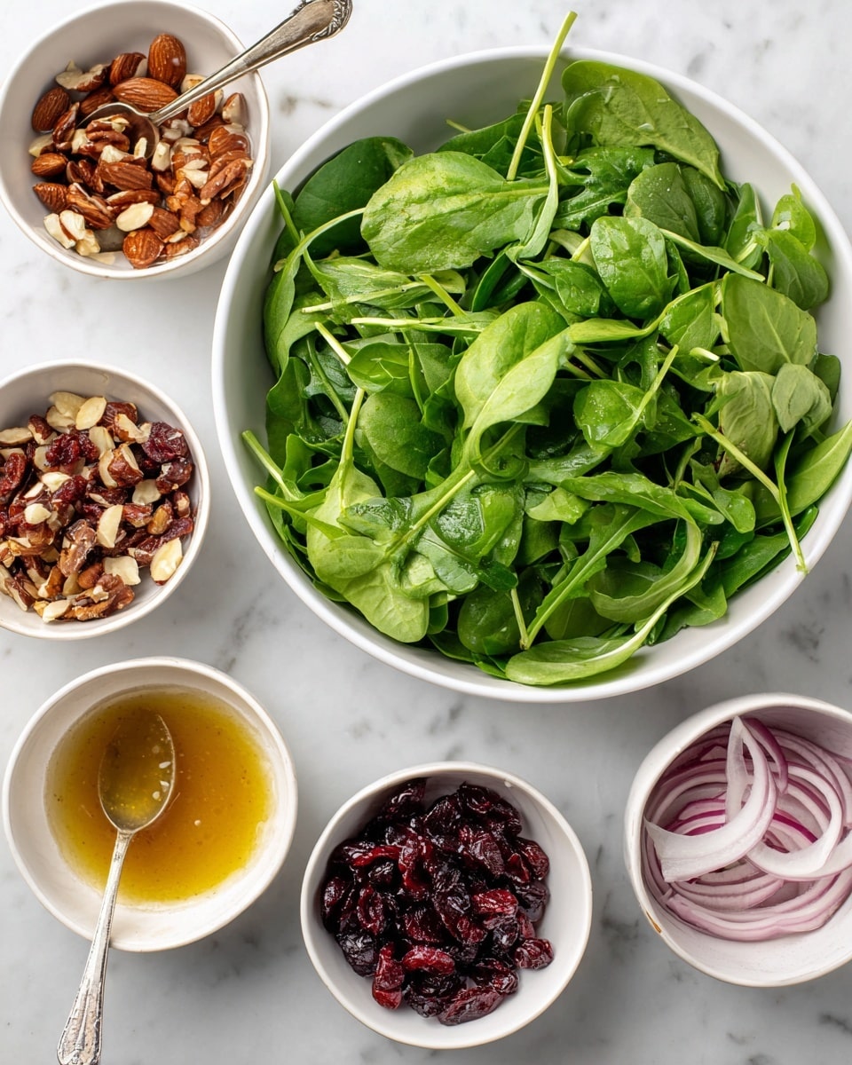 The image shows six white bowls placed on a white marbled surface, each bowl containing a different salad ingredient or dressing. The largest bowl, centered slightly to the right, holds fresh green arugula leaves with smooth textures, slightly curved edges, and thin stems. Surrounding the main bowl, from top left clockwise, are smaller white bowls: one filled with chopped dates and almonds showing dark brown chunks with a rough texture, one with vinaigrette dressing that is amber-colored and smooth with a spoon inside, one with thin, pale purple red onion slices that have a translucent quality, one with pear slices showing a light yellow flesh and brown skin, and lastly one with dark red dried cranberries that have a wrinkled texture. Each bowl is clearly separated, showing the variety of colors and textures. Photo taken with an iphone --ar 4:5 --v 7
