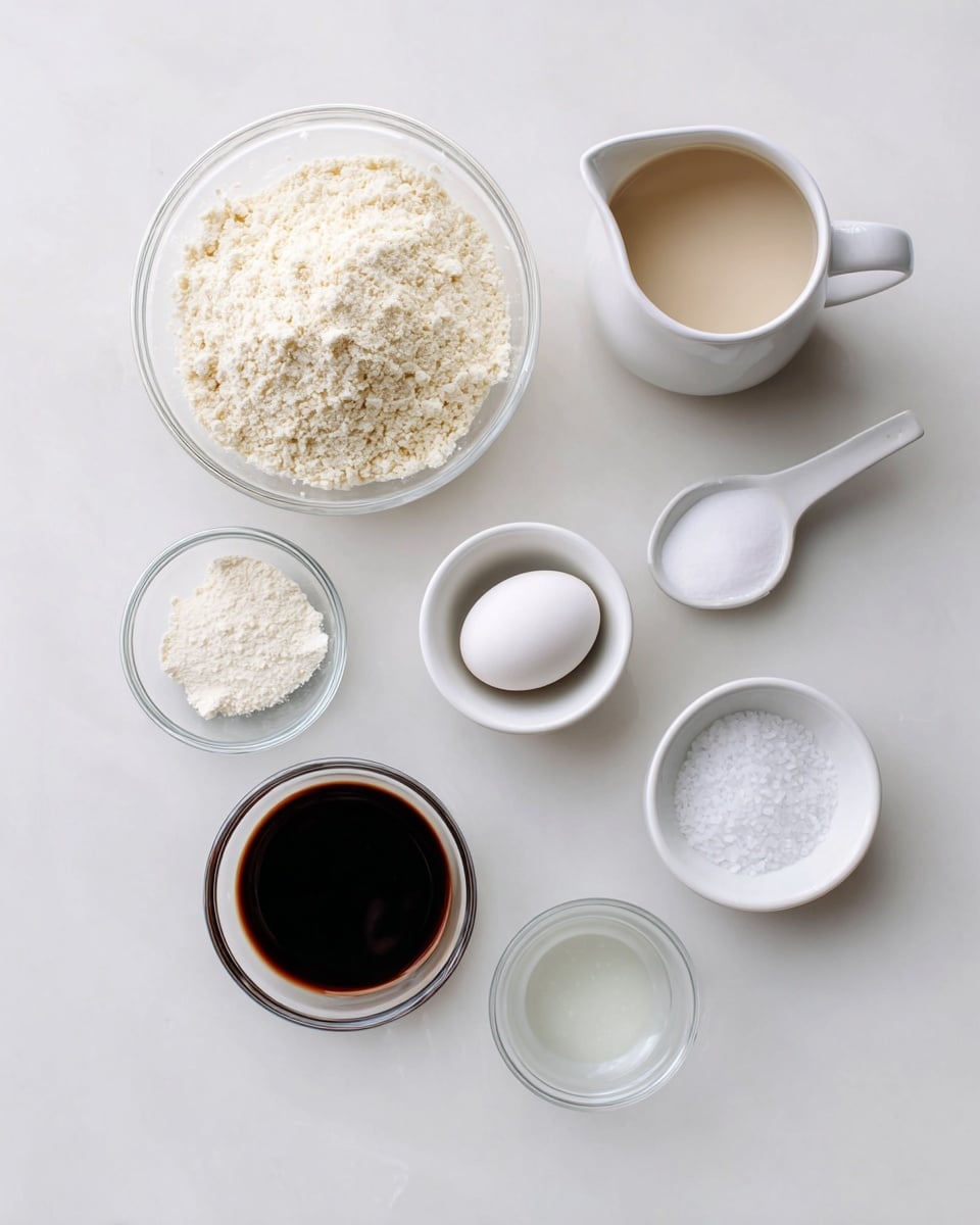 A top view of seven small white dishes and clear glass bowls arranged on a white marbled surface, holding different ingredients. The largest clear bowl on the top left is filled with a pale, crumbly powder. To its right is a white pitcher filled with a light beige liquid. Below the pitcher is a white cup holding a single white egg. Around the center are two small clear bowls, one with a white powder and one with a dark brown liquid. On the far right is a small white spoon-shaped dish filled with coarse white salt. At the bottom is a small white bowl with a clear liquid inside. photo taken with an iphone --ar 4:5 --v 7
