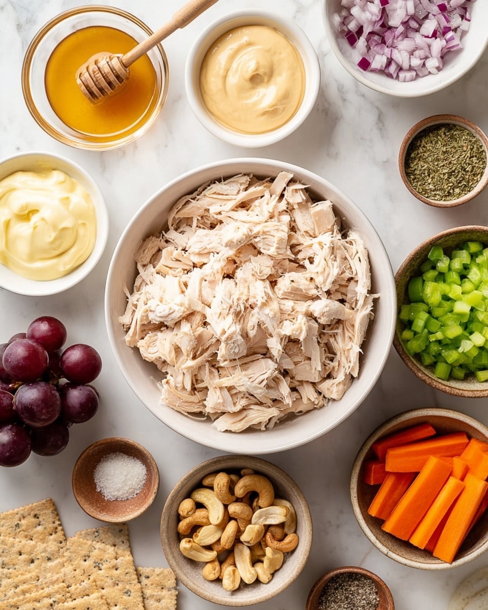 A top view of a large white bowl filled with shredded pale cooked chicken pieces placed in the center on a white marbled surface. Surrounding the chicken are smaller white and brown bowls, each containing different ingredients: smooth pale yellow mayonnaise on the top left, light brown honey with a wooden dipper above the chicken, finely chopped red onion top right, fresh green chopped celery below the chicken, whole light brown cashews to the right, bright orange thin carrot sticks on the left, coarse salt and pepper mix in a small bowl above the chicken, a small bowl with dried herb to the right, smooth creamy mustard in a bowl below left, light beige powder in a small brown bowl on the lower left side, a few dark red grapes on the bottom left, and a few rectangular whole grain crackers at the bottom left corner. The scene is bright and clear with natural light, photo taken with an iphone --ar 4:5 --v 7