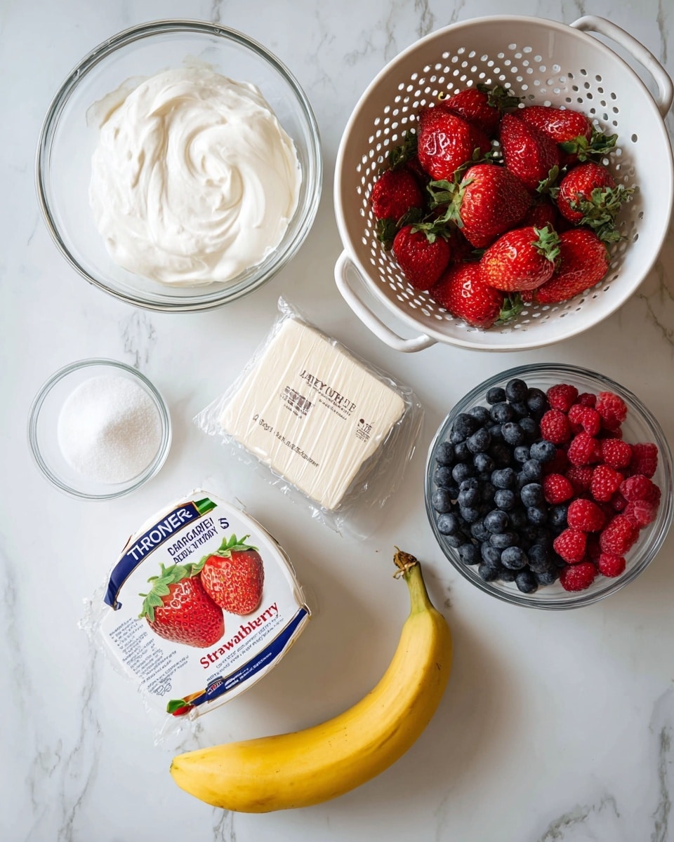 The image shows ingredients laid out on a white marbled surface, ready for a recipe. In the top left is a glass bowl filled with smooth white cream. To the right, a white colander holds bright red strawberries with green tops. Below the colander is a clear glass bowl half filled with two kinds of berries: dark blue blueberries on the left and red raspberries on the right. In the center is a wrapped block of cream cheese with beige packaging. To the left of this is a small bowl filled with white granulated sugar. Below the sugar bowl is a slightly spotted yellow banana. On the left side of the banana is a container of strawberry yogurt with a white lid featuring strawberry images and green and red text. Photo taken with an iphone --ar 4:5 --v 7