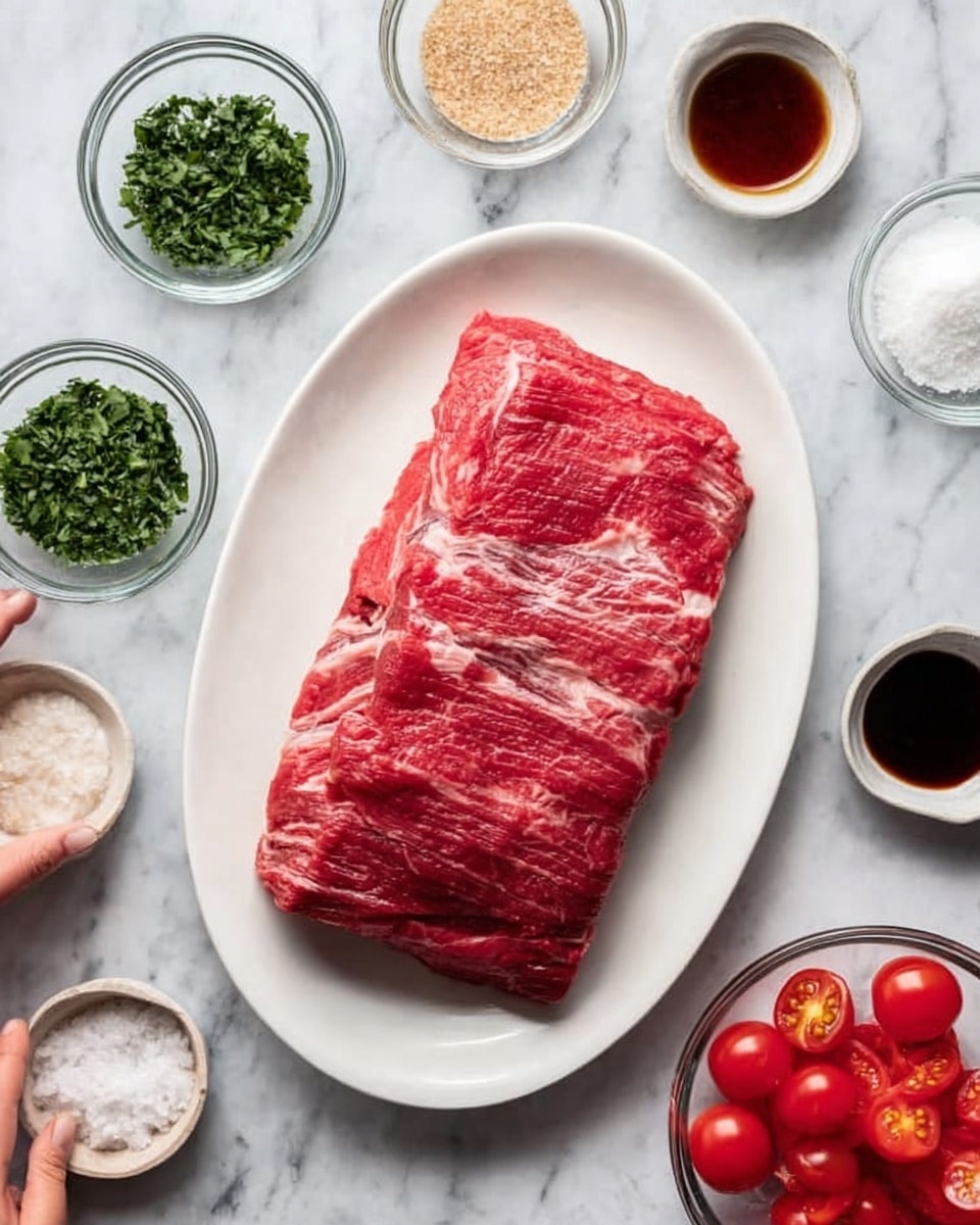 A large piece of raw red meat with visible muscle fibers lies flat in the center of a white oval plate. Surrounding the plate are six small transparent glass bowls arranged in a loose circle, each holding different ingredients: chopped green herbs, coarse white salt, light brown granulated substance, dark brown liquid, a small clear liquid, and halved cherry tomatoes with seeds visible. The background is a white marbled surface, and a woman's hand gently touches the side of the plate. Photo taken with an iphone --ar 4:5 --v 7