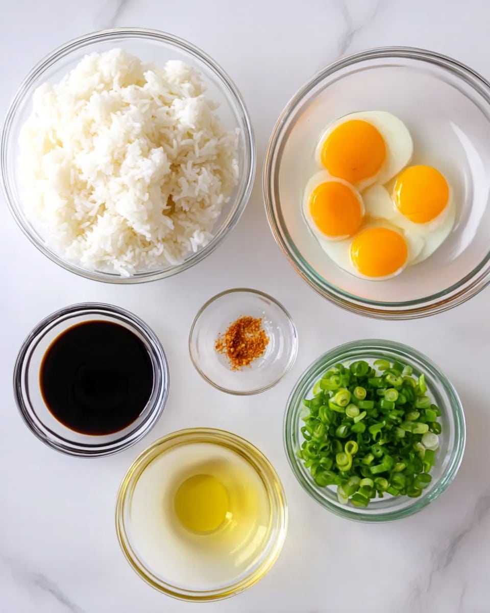 The image shows six clear glass bowls arranged on a white marbled surface. The largest bowl, placed on the left side, is filled with white rice. Near the center right, there is a medium-sized bowl holding four raw eggs with yellow yolks and clear whites. Above this, a smaller bowl contains dark soy sauce, and to the right of it is a bowl filled with chopped green onions, showing bright green rings. Below the soy sauce, another bowl holds light yellow cooking oil, and next to it, on the far right, a small bowl contains a small amount of orange-brown spice or seasoning. The arrangement is clean and items are neatly spaced. Photo taken with an iphone --ar 4:5 --v 7