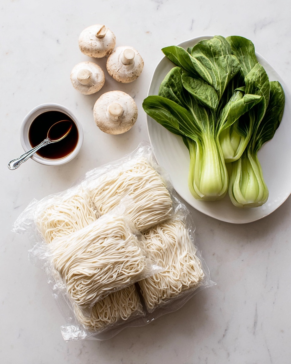 Three bundles of pale white noodles wrapped in clear plastic lie stacked on a white marbled surface. To the upper right, a white plate holds several bright green bok choy vegetables with smooth stems and leafy tops, alongside four light beige mushrooms with round caps and short stems. On the upper left side, a small white bowl contains a dark, glossy soy sauce with a small silver spoon resting inside. The scene is bright and clean, with all items clearly arranged and displayed. photo taken with an iphone --ar 4:5 --v 7