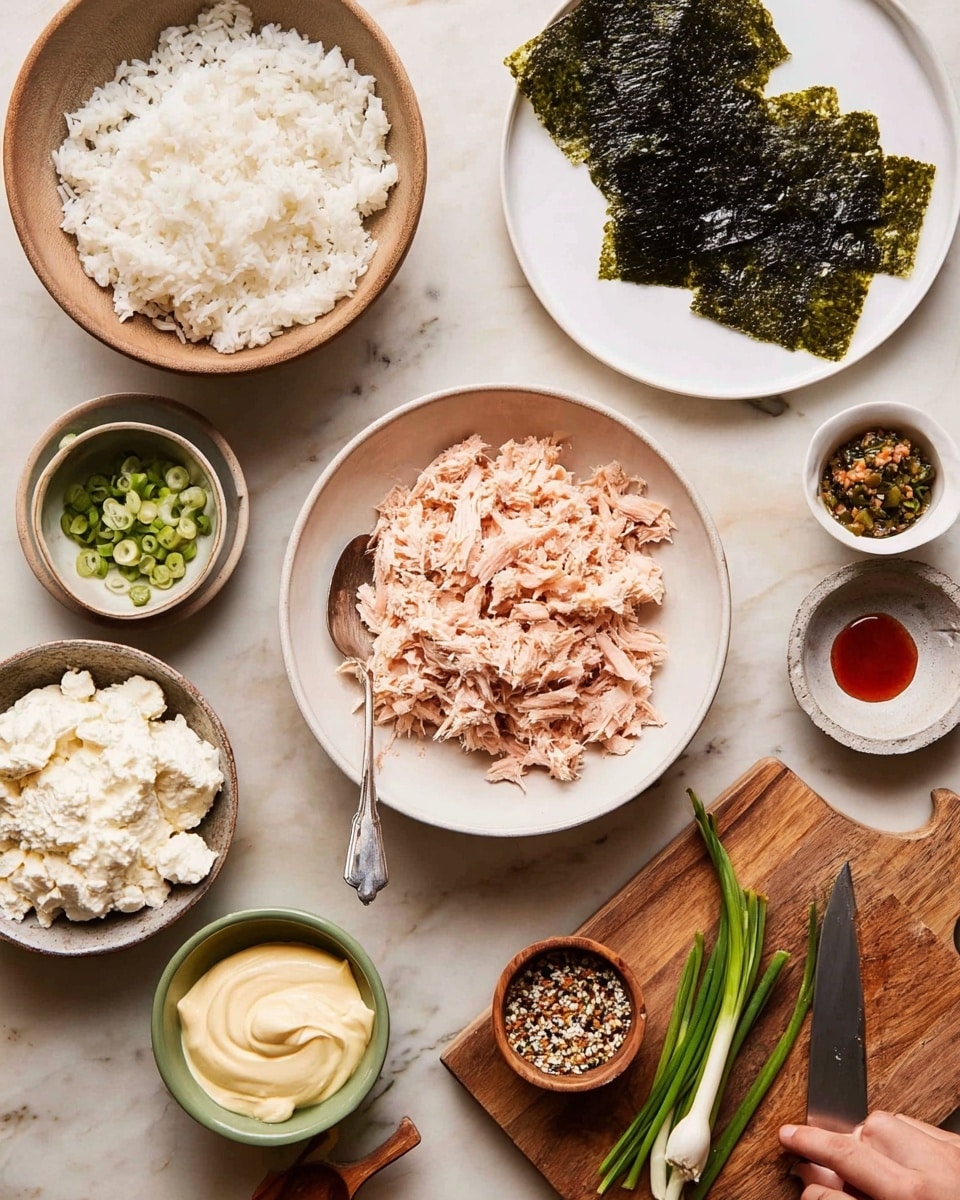 The image shows a variety of ingredients arranged on a white marbled surface. At the center, there is a white bowl filled with light pink shredded cooked fish. Behind it, on a white plate, are several dark green dried seaweed sheets. To the left, there is a white bowl filled with fluffy white rice, and a silver spoon resting inside it. Below the rice bowl is a white bowl with thick creamy white cheese. Next to the cheese is a small green bowl containing pale yellow mayonnaise. To the right of the seaweed sheets are two small bowls: one with a mix of green herbs and seeds and a wooden spoon inside, and another with a small amount of red sauce. At the top right, on a white plate, are green sliced scallions. In the bottom right corner, a wooden cutting board holds more chopped scallions and a knife with a wooden handle. A woman’s hand is partially visible, holding the knife. The photo taken with an iphone --ar 4:5 --v 7