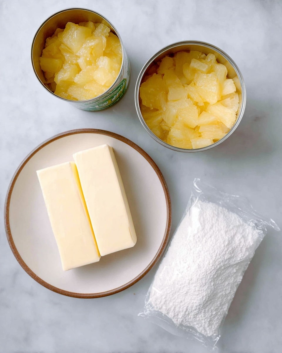 The image shows two open cans filled with yellowish, chunky pineapple on the top center of a white marbled surface. Below the cans, there is a white plate with a brown rim holding two pale yellow sticks of butter side by side. To the right of the plate, there is a clear plastic bag filled with white powder, likely flour or sugar, lying flat on the same white marbled surface. The setup is clean and simple, focusing on the ingredients. photo taken with an iphone --ar 4:5 --v 7