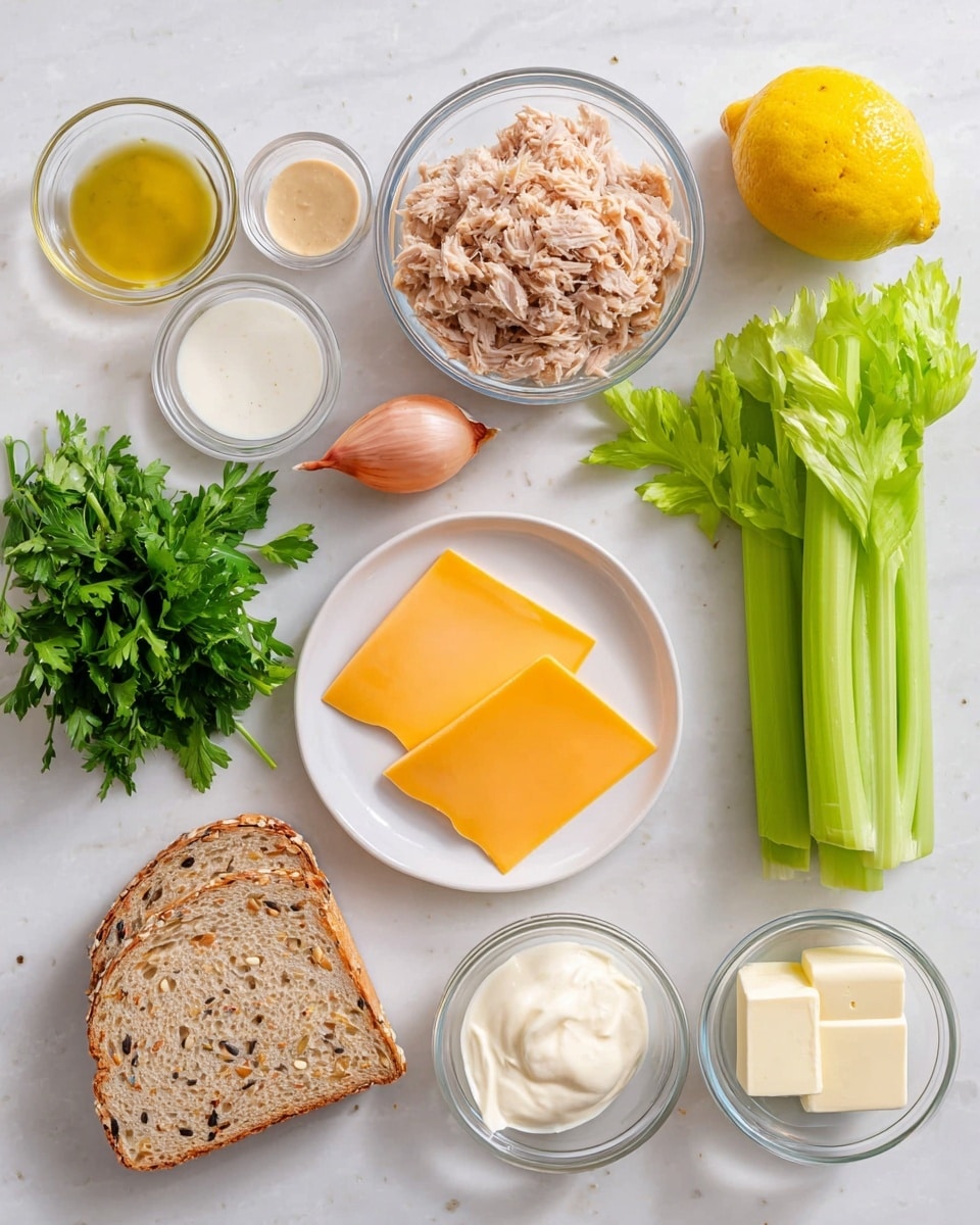The image shows ingredients laid out on a white marbled surface in a neat arrangement. There are two bright green celery sticks on the right side, next to a whole yellow lemon and a small light pink shallot. A clear glass bowl filled with light brown shredded tuna sits near the center. On the left, there is a small bunch of fresh green parsley. Below the parsley is a white bowl holding several orange slices of cheddar cheese. To the right of the cheese is a single slice of light brown bread with seeds. Above the bread are three clear glass bowls containing light brown mustard sauce, white creamy mayonnaise, and a small mix of salt and pepper. A small glass bowl with two square pieces of butter is next to the mustard. The ingredients are all placed clearly and carefully for easy viewing photo taken with an iphone --ar 4:5 --v 7