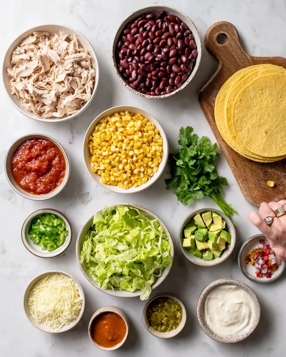 The image shows many small white bowls and a white plate on a white marbled surface, each with different ingredients for making tacos. There are shredded light beige cooked chicken pieces in one bowl at the top left, dark red beans in another bowl above it, and bright yellow corn kernels in a bowl near the center. A small bunch of fresh green cilantro sits above a wooden board holding a stack of yellow corn tortillas. Next to the tortillas, there is a bowl with chopped green lettuce and a smaller bowl with diced green avocado pieces. A white bowl near the bottom left has finely shredded white cheese. Surrounding these are small bowls with various sauces and spices, including bright red salsa, white sour cream, yellow-green chopped peppers, small red pieces of chopped onion, and a small bowl with bright orange hot sauce. A woman's hand with a silver ring reaches towards the lettuce bowl. All items are neatly arranged, showing clear colors and textures. Photo taken with an iphone --ar 4:5 --v 7