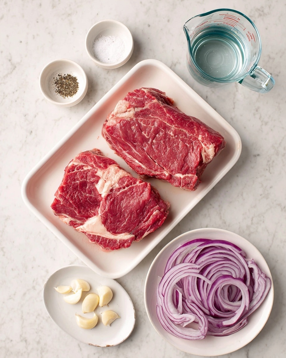 The image shows a white tray in the center holding two large pieces of bright red chuck roast with white fat marbling. Above the tray are two small white bowls with coarse salt and black pepper. To the right of the tray is a clear glass measuring cup filled with water sitting on a white marbled surface. Below the tray, a small white plate holds peeled garlic cloves, and next to it is a white bowl filled with thinly sliced rings of red onion, displaying purple and white layers. The whole arrangement is on a white marbled surface. photo taken with an iphone --ar 4:5 --v 7