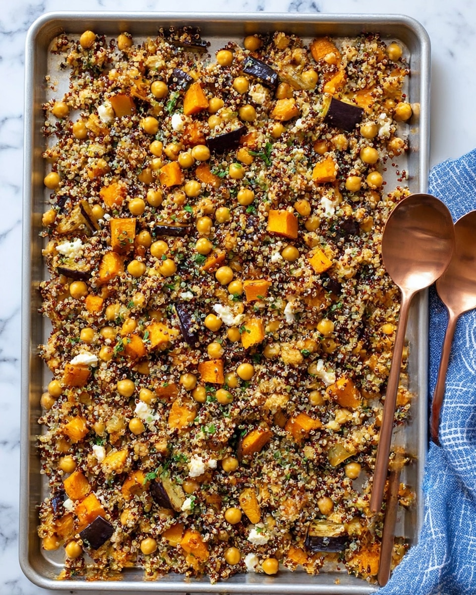 The image shows a silver baking tray filled with a mixed dish spread evenly. The dish contains small, round chickpeas in a light yellow shade, dark red and white quinoa grains, and orange cubes of roasted vegetables that look like squash or sweet potato. There are also small chunks of white cheese scattered throughout, along with bits of chopped green herbs. Darker pieces of roasted eggplant or a similar vegetable add contrast across the tray. Two copper-colored serving spoons rest on the right side of the tray. The background is a white marbled surface with a blue and white cloth partially visible under the top right corner of the tray. Photo taken with an iphone --ar 4:5 --v 7