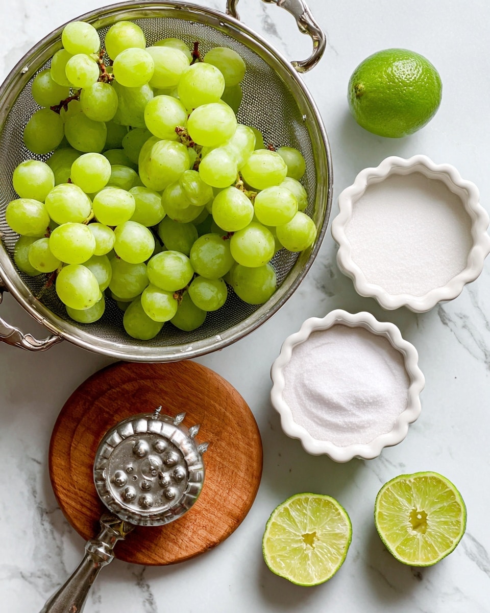 The image shows a top view of fresh green grapes filling a metal colander on the left side of the frame. To the right, two white scalloped bowls hold white powdery substances labeled monk fruit and citric acid. At the bottom left, a wooden round board holds a metal lime juicer and two halves of a bright green lime. The whole setup is placed on a white marbled surface. Photo taken with an iphone --ar 4:5 --v 7