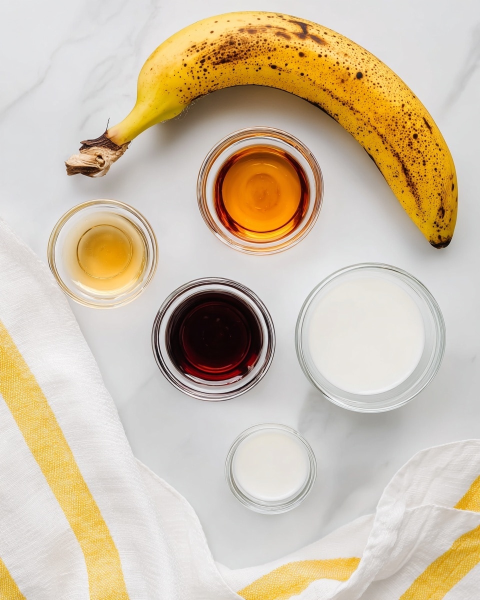 In the image, a ripe yellow banana with brown spots lies diagonally on a white marbled surface, near the top left corner. Below the banana are five small clear glass bowls arranged in a loose circular pattern. One bowl contains a thin, amber-colored liquid, another holds a dark brown liquid, a third is filled with white milk, a fourth appears empty with clear glass showing, and two tiny white bowls sit nearby, one of them also empty. A white cloth with yellow stripes gathers softly in the top right and bottom right corners, framing the ingredients gently. Photo taken with an iphone --ar 4:5 --v 7