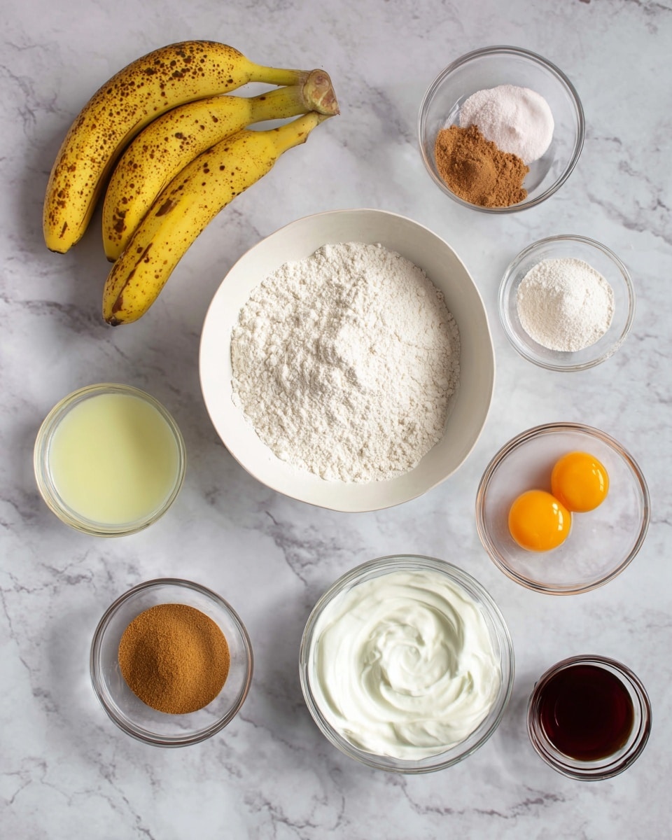 The image shows a white marbled surface with various ingredients arranged neatly. In the center, there is a white bowl filled with white flour. Above and to the left, three yellow bananas with brown spots lie together. To the right of the bananas, a small clear glass bowl holds three powders: white, light pink, and brown. Below that, another clear bowl contains a golden brown sugar mixture. Below the flour bowl to the left, there is a clear glass bowl with a pale yellow liquid. Next to it on the right, another clear bowl shows two raw eggs with bright orange yolks. To the right of the eggs, there is a clear bowl with white creamy yogurt. Finally, at the bottom right, a small clear bowl contains a dark brown liquid. Photo taken with an iphone --ar 4:5 --v 7