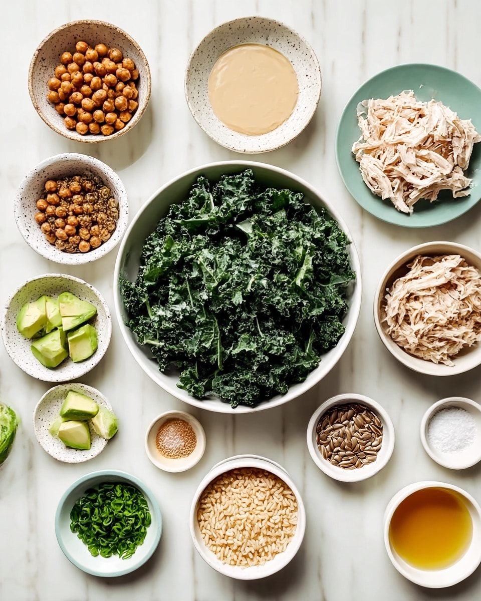 The image shows a top view of many small white bowls and plates arranged on a white marbled surface. In the center is a large white bowl filled with dark green curly kale leaves. To the right, a medium white bowl contains shredded light-colored chicken pieces. Below it, a similar bowl is filled with cooked brown rice. To the left of the kale, there is a white bowl with brown roasted chickpeas, and above it, a speckled white bowl holds pale green avocado cubes. Small white bowls and dishes around them hold various small amounts of ingredients such as chopped green chives, a light beige thick sauce, sunflower seeds, light brown powder, salt, and pale yellow oil or honey. Everything is neatly placed and colorful against the clean white marbled background. Photo taken with an iphone --ar 4:5 --v 7