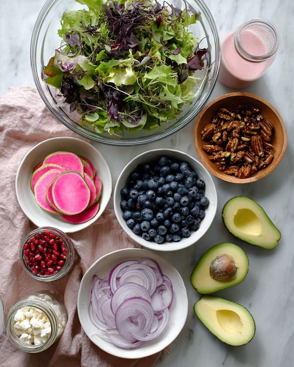 The image shows several bowls and fresh ingredients on a white marbled surface. At the top is a large glass bowl filled with green and purple leafy salad mix with some delicate stems. Below it is a white bowl filled with fresh, dark blue blueberries, and next to that, a small wooden bowl with glossy caramelized nuts that look crunchy. To the left, there is a white bowl with neatly stacked round slices of pink and green watermelon radish. Below the nuts is a small white bowl with bright red pomegranate seeds. On the right side, there are two avocado halves, one with the brown seed and the other empty, lying on a soft dusty pink cloth. At the bottom, a white bowl holds thinly sliced light purple onions, and next to it, another white bowl contains crumbled white cheese. On the left side, there is a small clear jar of light pink salad dressing or sauce. The setting looks clean, fresh, and inviting, photo taken with an iphone --ar 4:5 --v 7