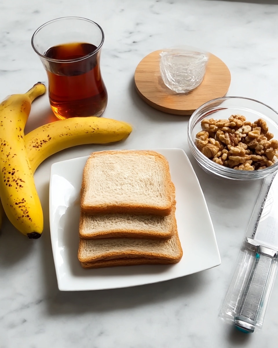 The image shows a white square plate holding four slices of light tan bread stacked evenly in the center. To the right of the plate, there are two yellow bananas with small brown spots, placed on a white marbled surface. Next to the bananas is a clear, small glass bowl filled with light brown walnut pieces. Behind the bowl, a clear glass of dark amber tea sits on a round wooden coaster. On the far right side, a stainless steel knife with a turquoise handle lies on the white marbled surface under a clear plastic peeler. The whole scene is set on a white marbled surface and has a clean, simple look. Photo taken with an iphone --ar 4:5 --v 7