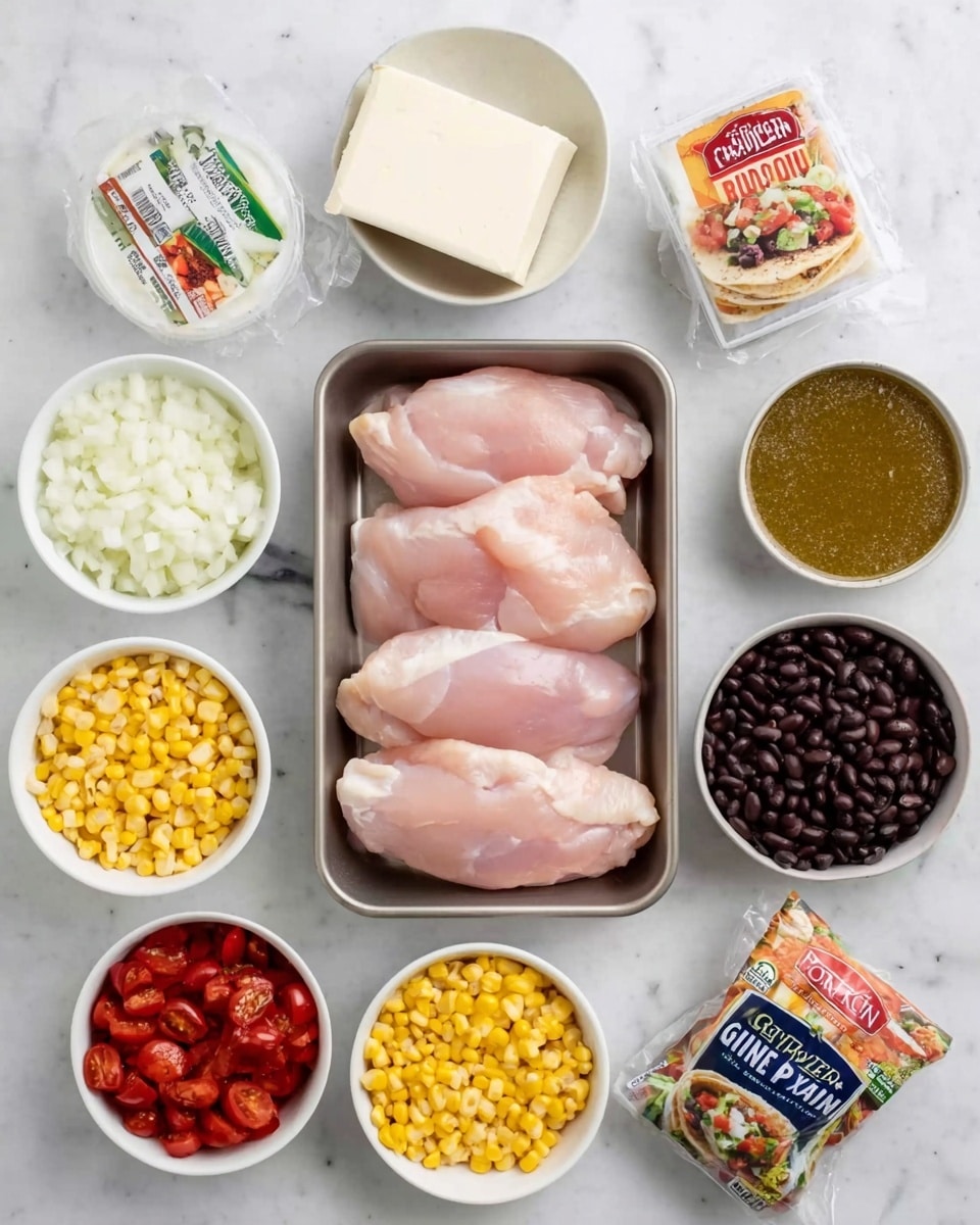 A top-down view of cooking ingredients laid out on a white marbled surface: four pieces of raw light pink chicken laid side by side in a small metal tray in the center. Surrounding the tray in small white bowls are diced white onions, a block of white cream cheese, yellow corn kernels, black beans, green salsa, and red diced tomatoes. There is also a small round container of chicken broth and two packets of seasoning labeled