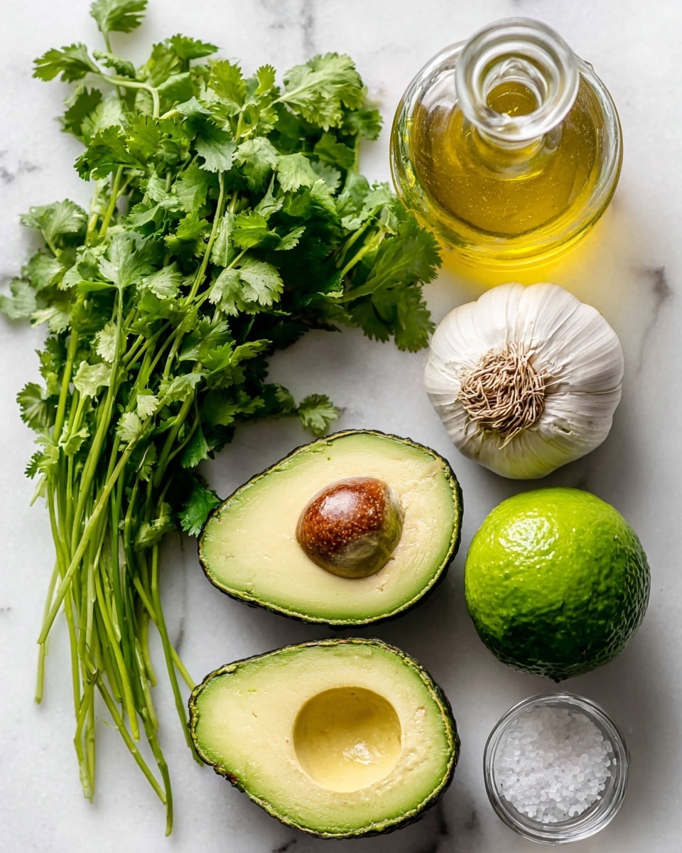 The image shows fresh ingredients arranged on a white marbled surface. On the left side, there is a bunch of bright green cilantro with long thin stems and leafy tops. In the lower center, two halves of an avocado are placed side by side, one with a large brown seed and the other with a smooth green inside. To the right of the avocado, there is a whole lime with bright green textured skin. Above the lime, a whole garlic bulb with a white, slightly purple-tinted outer skin is visible. Near the top center, there is a clear glass bottle filled with golden-yellow oil, which has a simple stopper. On the far right, a small clear glass salt container with a metal lid is also shown. Photo taken with an iphone --ar 4:5 --v 7